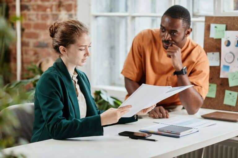 Young confident economist or lawyer checking documentation